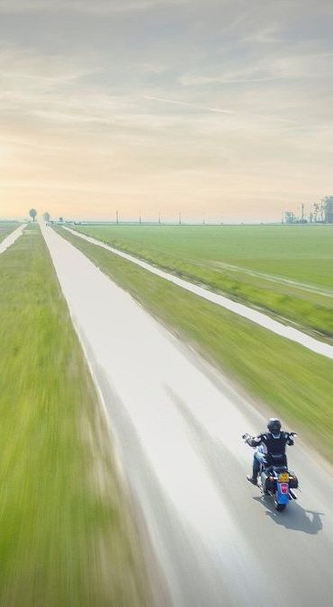 Rider on a cruiser heading down a country road